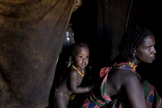 A Gabbra woman in her hut with her children