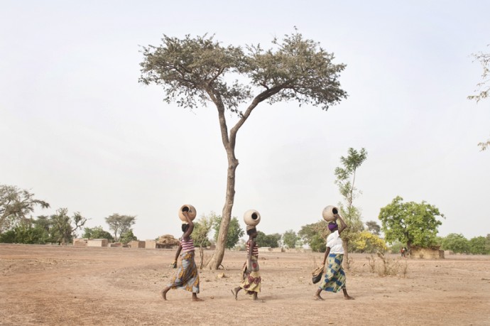 Simple and hard life, carrying clay pots to collect water at a well outside the village  - © Giulio Napolitano