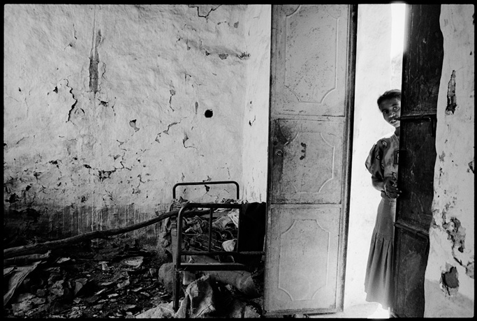 A young girl on the door of her house now destroyed, Enda Gherghis - © Giulio Napolitano