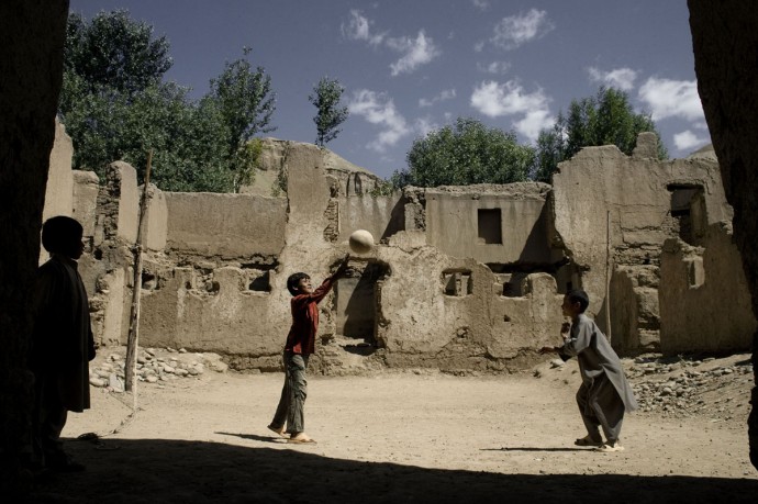 Children playing in a bombed courtyard, Bamyan